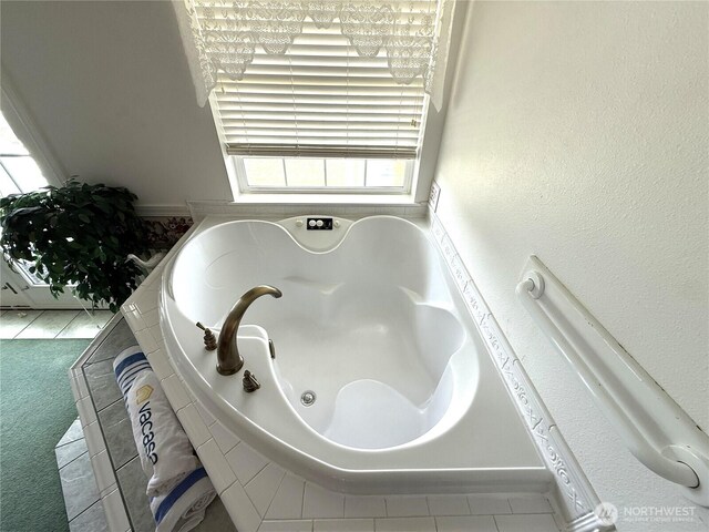 full bath featuring tile patterned flooring and a bath