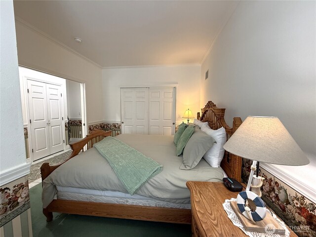 bedroom with crown molding, carpet floors, and a closet