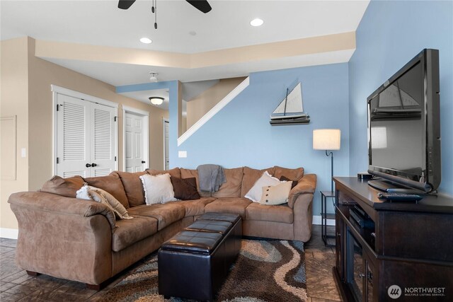 living area featuring baseboards, a ceiling fan, and recessed lighting