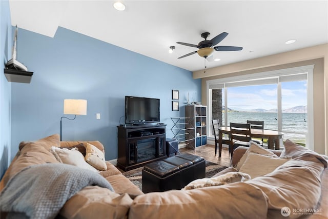 living room featuring ceiling fan, baseboards, wood finished floors, and recessed lighting