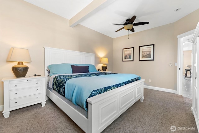 carpeted bedroom featuring baseboards, a ceiling fan, and beam ceiling
