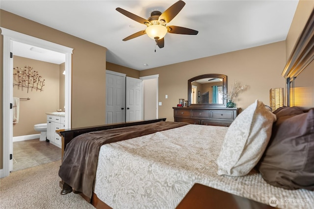 bedroom featuring connected bathroom, ceiling fan, baseboards, and carpet floors