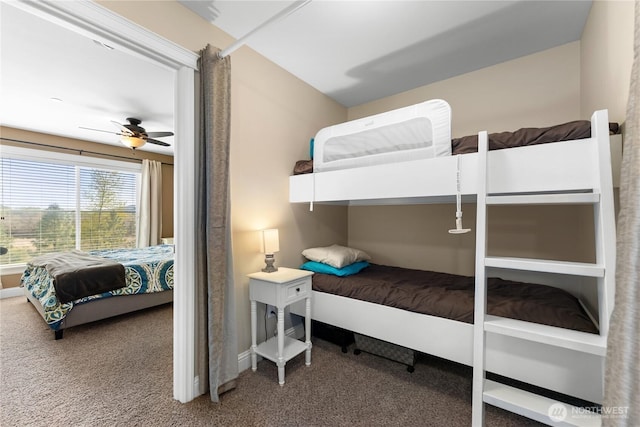 carpeted bedroom with baseboards and a ceiling fan