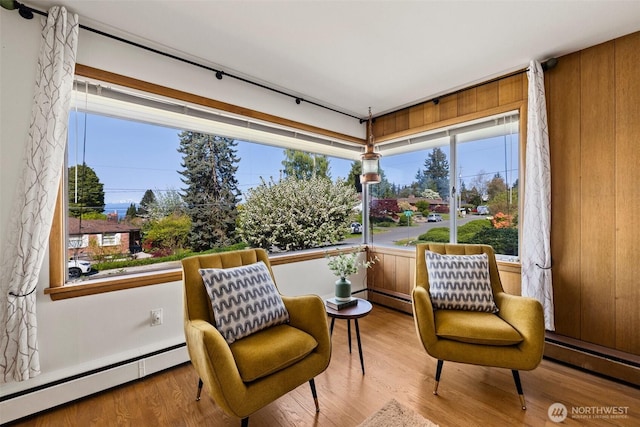 interior space with plenty of natural light, light wood-style flooring, and a baseboard radiator