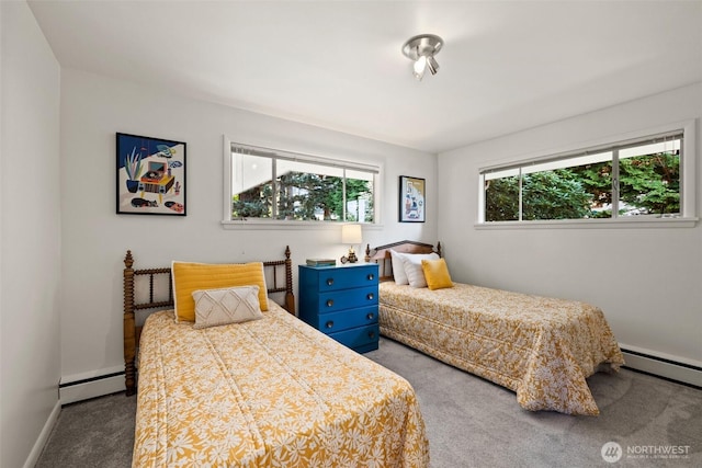 bedroom with baseboard heating, baseboards, and carpet