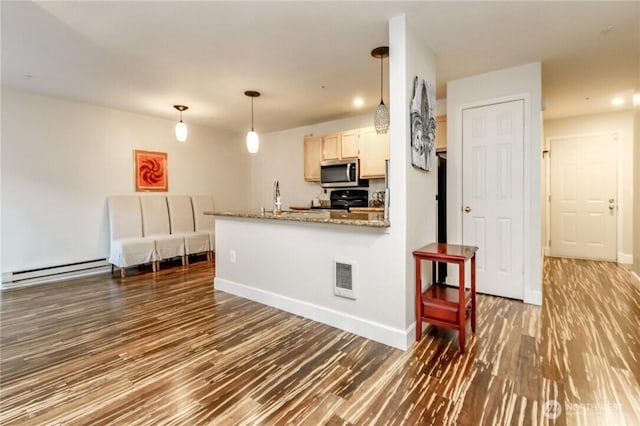 kitchen with a baseboard heating unit, stainless steel microwave, visible vents, stove, and wood finished floors