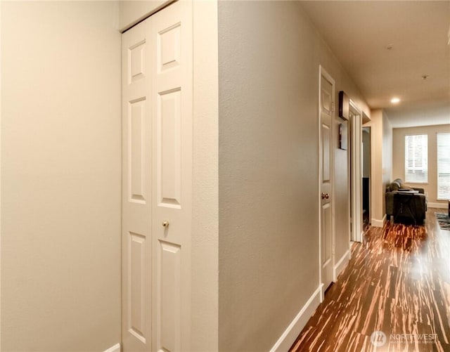 corridor with baseboards, dark wood-style floors, and recessed lighting