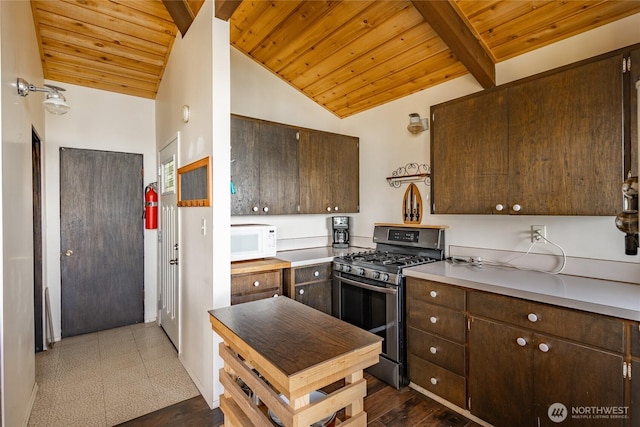 60 Eliza Is, Bellingham, WA 98226 - kitchen with dark brown cabinetry, stainless steel range with gas cooktop, wooden ceiling, lofted ceiling, and white microwave