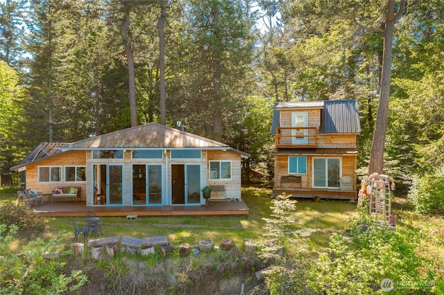 60 Eliza Is, Bellingham, WA 98226 - back of property featuring a lawn, metal roof, a standing seam roof, and a deck