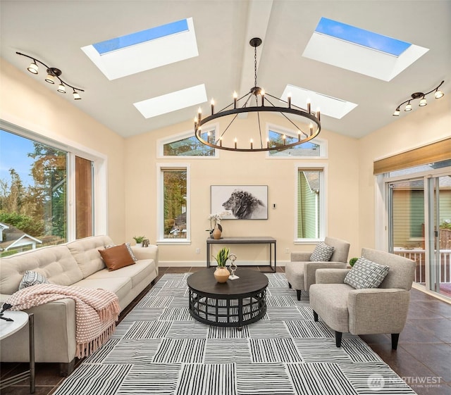 interior space with track lighting, plenty of natural light, and a notable chandelier