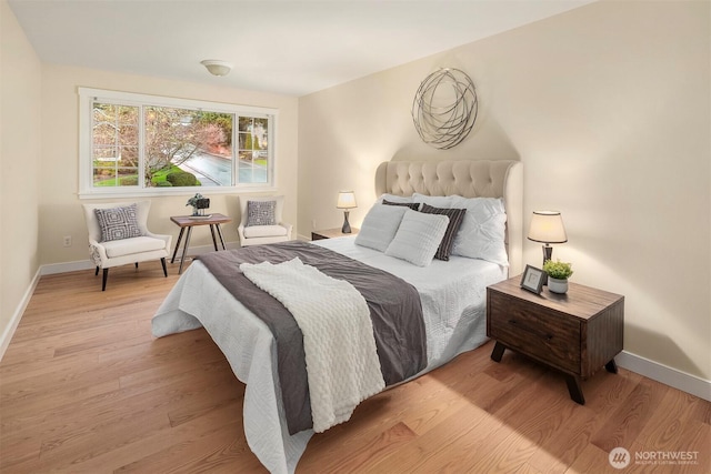bedroom with light wood-type flooring and baseboards