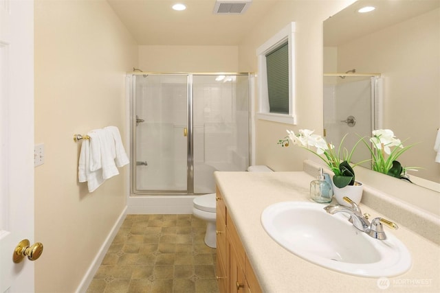 bathroom featuring toilet, visible vents, recessed lighting, a shower stall, and vanity