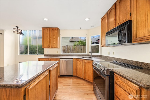 kitchen featuring stainless steel dishwasher, a healthy amount of sunlight, black microwave, range with electric stovetop, and a sink