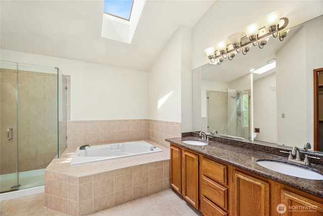 full bathroom with a skylight, a shower stall, a sink, and a bath