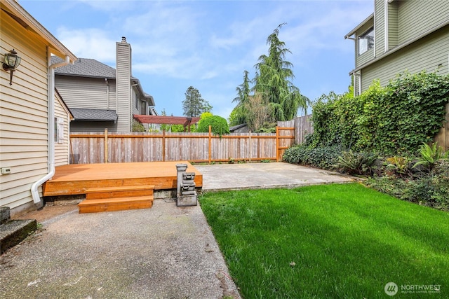 view of yard with a fenced backyard, a patio area, and a deck