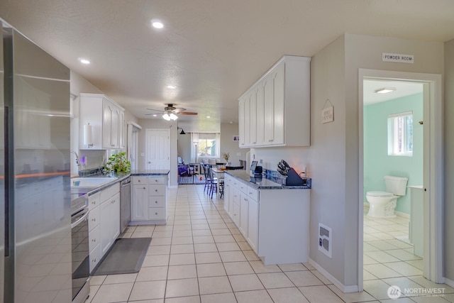 4647 Ohio St, Longview, WA 98632 - kitchen featuring white cabinetry, stainless steel appliances, and a sink
