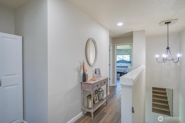 4647 Ohio St, Longview, WA 98632 - corridor featuring wood finished floors, baseboards, recessed lighting, and a chandelier
