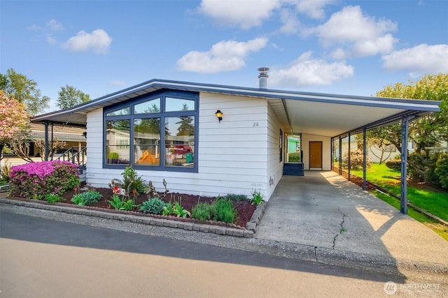 view of home's exterior with driveway and a carport