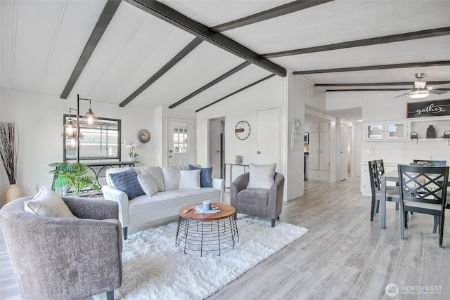 living room with a ceiling fan, lofted ceiling with beams, and light wood-style flooring