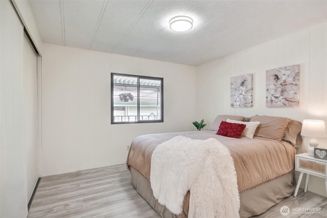 bedroom with a closet and light wood-style flooring
