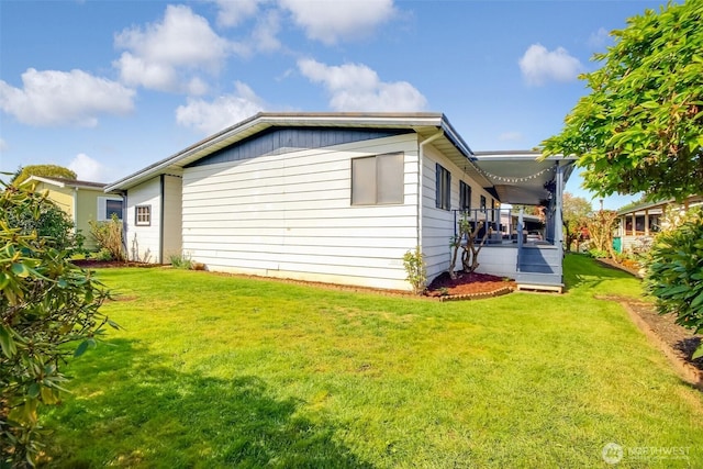 view of property exterior with a lawn and covered porch