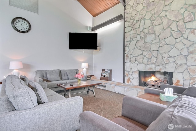 living area featuring visible vents, carpet floors, a stone fireplace, high vaulted ceiling, and wood ceiling
