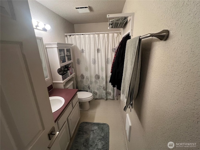 90 E Connemara, Shelton, WA 98584 - bathroom featuring a textured wall, a textured ceiling, vanity, curtained shower, and toilet