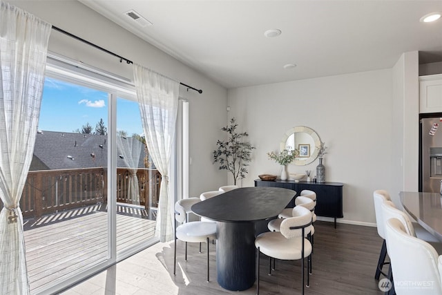 dining room featuring baseboards, wood finished floors, visible vents, and recessed lighting