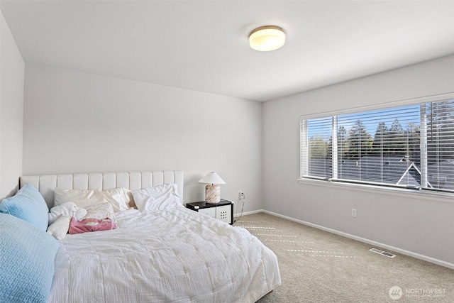 bedroom featuring carpet floors, visible vents, and baseboards