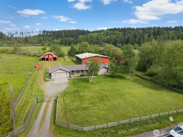 aerial view of property and surrounding area featuring a forest