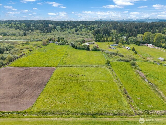 aerial view of sparsely populated area featuring a forest