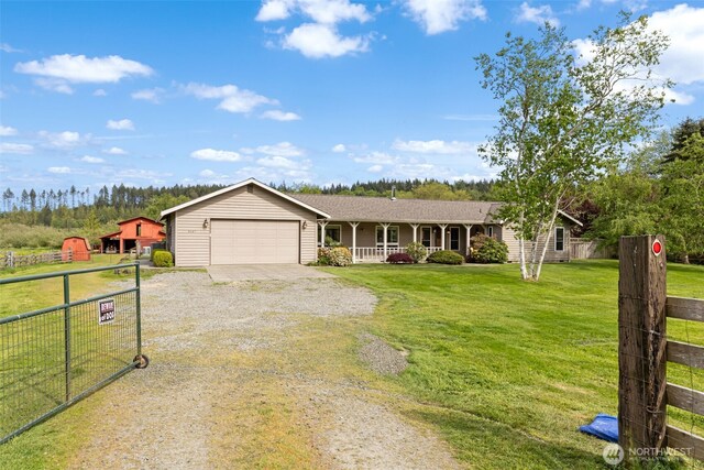 single story home featuring covered porch, driveway, and a garage