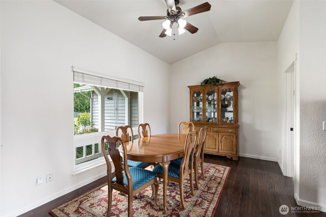 dining room featuring lofted ceiling, dark wood-style flooring, ceiling fan, and baseboards