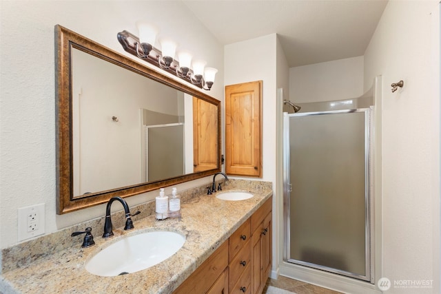 full bathroom with a shower stall, double vanity, and tile patterned flooring
