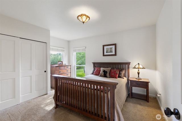 carpeted bedroom featuring baseboards