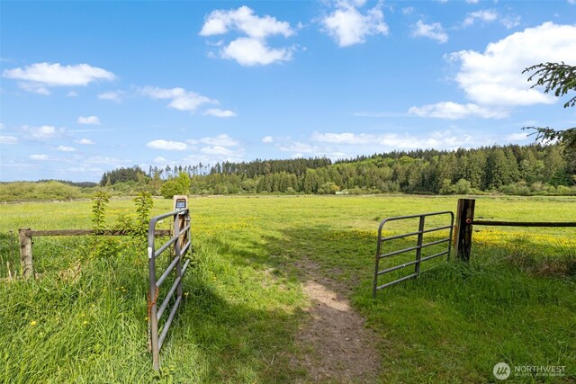 gate with a view of countryside, a view of trees, and fence