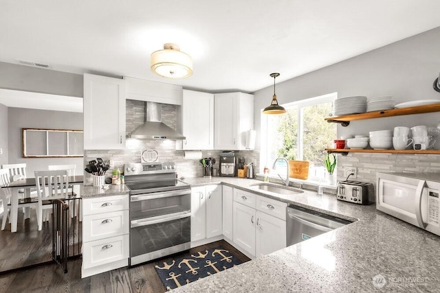 4 Dakota Ln, Elma, WA 98541 - kitchen featuring wall chimney exhaust hood, a sink, appliances with stainless steel finishes, and tasteful backsplash