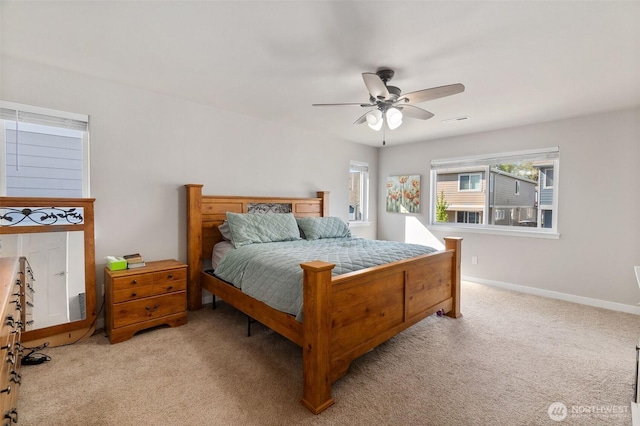carpeted bedroom featuring visible vents, baseboards, and ceiling fan