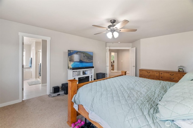 bedroom with ensuite bath, a ceiling fan, baseboards, and carpet
