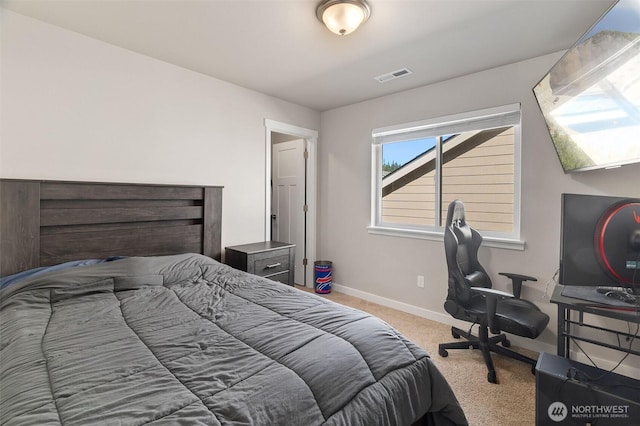 carpeted bedroom with baseboards and visible vents