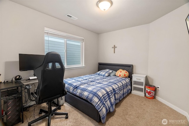 carpeted bedroom featuring baseboards and visible vents