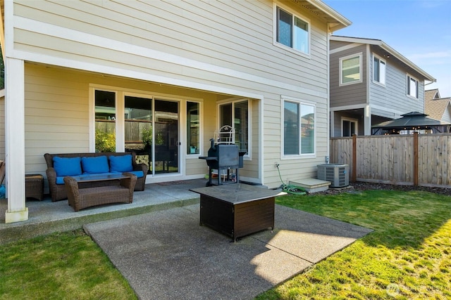 back of property featuring an outdoor living space, a patio area, fence, and a yard