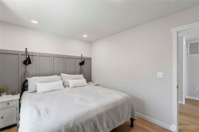 bedroom featuring recessed lighting, wood finished floors, and visible vents