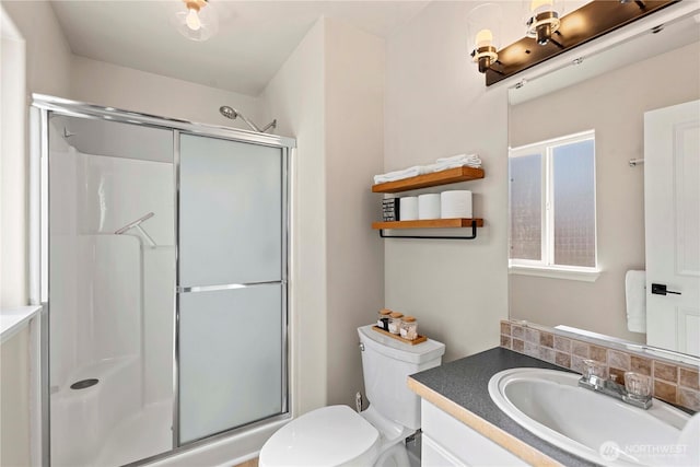 full bath with a shower stall, toilet, and vanity