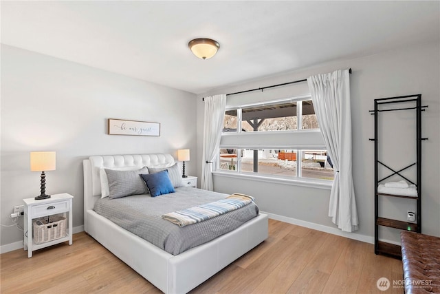 bedroom with baseboards and wood finished floors