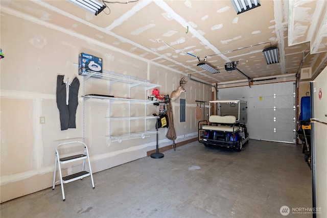 garage featuring electric panel and a garage door opener