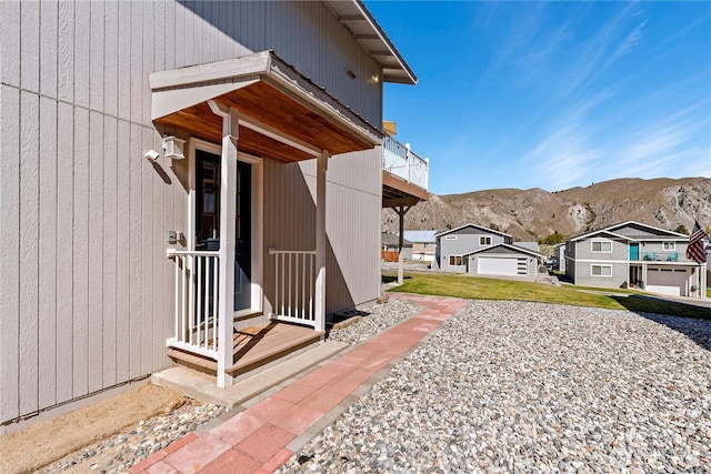 view of home's exterior with a residential view, a balcony, and a mountain view