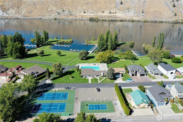 drone / aerial view featuring a residential view and a water view