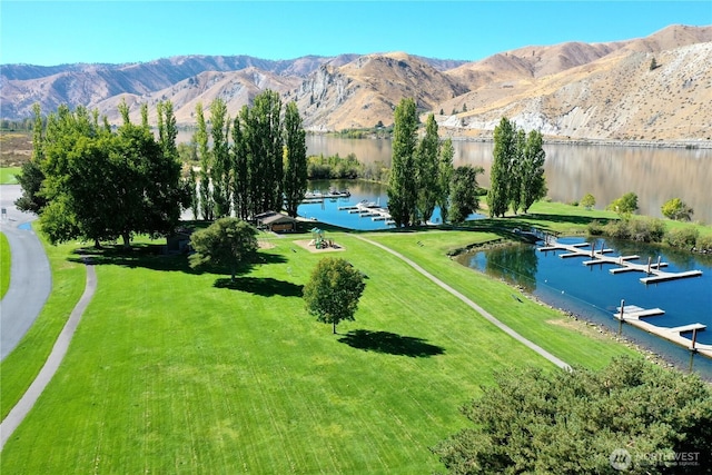 birds eye view of property with a water and mountain view