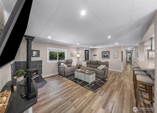2376 Forest View Dr, Bellingham, WA 98229 - living area with light wood-type flooring, a wood stove, and recessed lighting